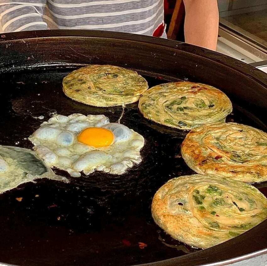 義豐蔥油派の鉄板で焼かれたネギ焼き餅。表面がきつね色に焼き上がっている