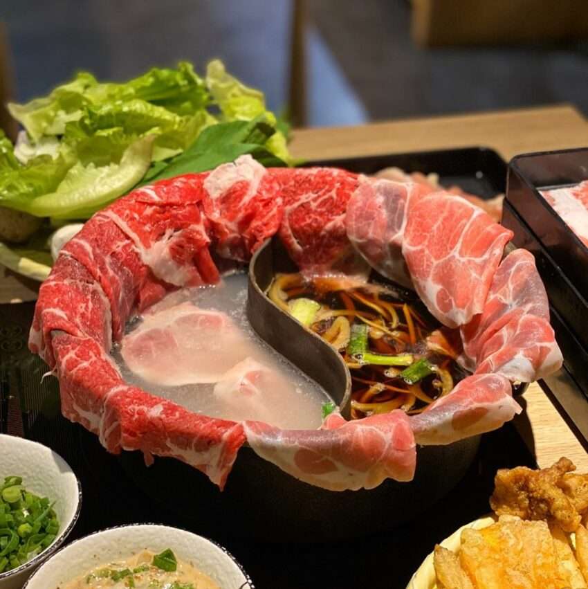 牛比蔥壽喜燒の鍋。季節野菜と肉スライスが彩りよく並ぶ