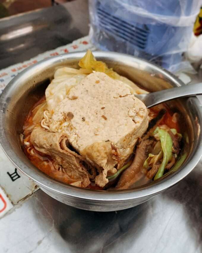 林記麻辣臭豆腐の盛り付け。臭豆腐に泡菜と赤唐辛子のスープが添えられている