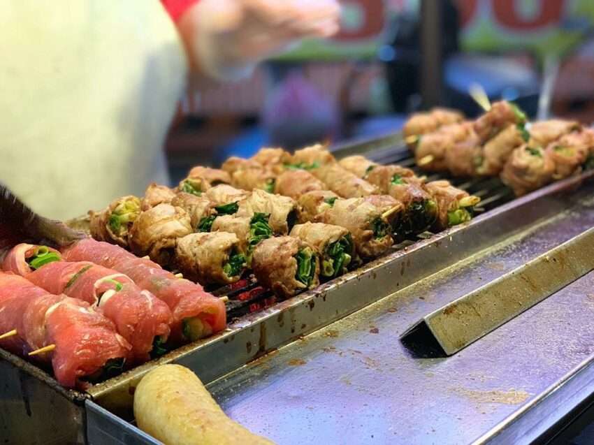 皇佳三星蔥肉串。豚肉とネギが交互に竹串に刺され、炭火焼きの香ばしい香りが漂う