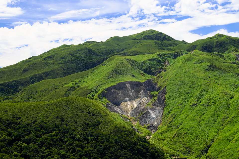 陽明山の噴気孔から白い硫黄蒸気が立ち上る火山地形