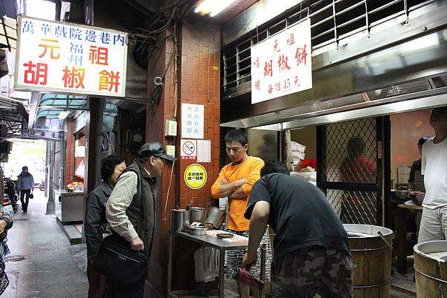 元祖胡椒餅の屋台で客に対応する店員の様子